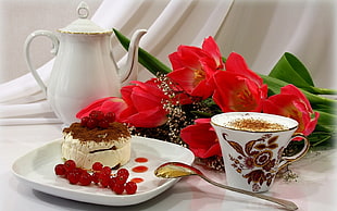 white and red cake, tea, and flowers