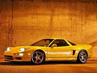 white coupe near concrete wall during nighttime