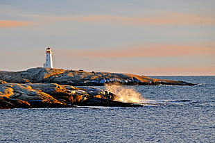 white lighthouse near ocean during daytime HD wallpaper