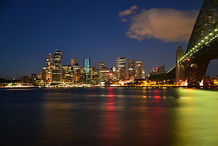 city buildings beside body of water during nighttime
