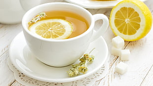 white ceramic teacup and platter, tea, food, lemons, sugar 