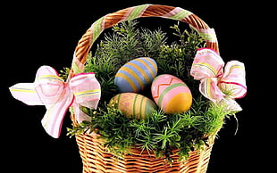 thee decorative eggs on basket