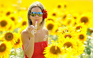 woman wearing red strapless dress and sunglasses