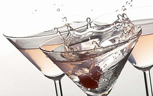 three cocktail wine glasses filled with clear liquid illustration