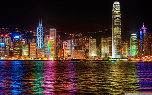 city light buildings beside body of water, skyline, night