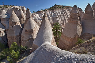 landscape photography of conical-shaped formation rock hills during daytime HD wallpaper