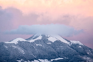 snow-capped mountain under cloudy sky