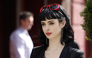 woman in black dress and red sunglasses