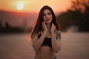 woman wearing black sports bra standing under sunset HD wallpaper