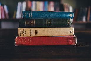 selective focus photography of four pile of books HD wallpaper