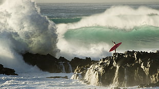 man on cliff near sea waves HD wallpaper