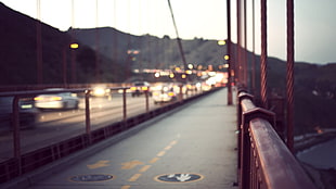 time lapsed photography of moving cars in the middle of bridge during sunset