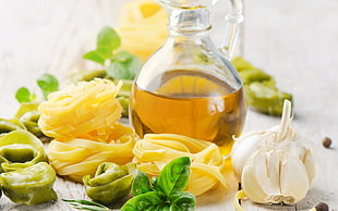 bottle of olive oil and garlic with pasta noodles HD wallpaper