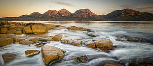 stone near at river against mountain, tasmania, freycinet national park HD wallpaper