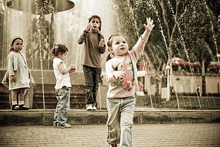 children playing on fountain