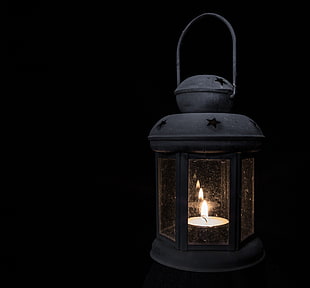 black candle lantern with ligted candle