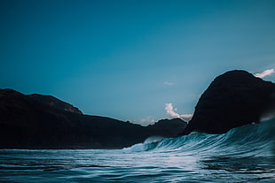 photo of sea and mountains