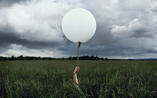 white inflatable balloon, balloon, hands, landscape