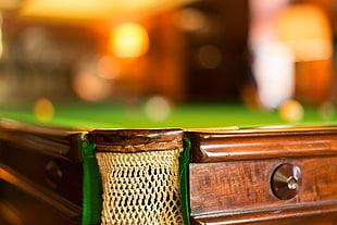 close-up photo of brown wooden pool table, bokeh, blurred, depth of field, sports