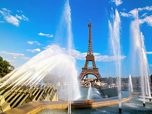 Eiffel tower near outdoor fountains during daytime