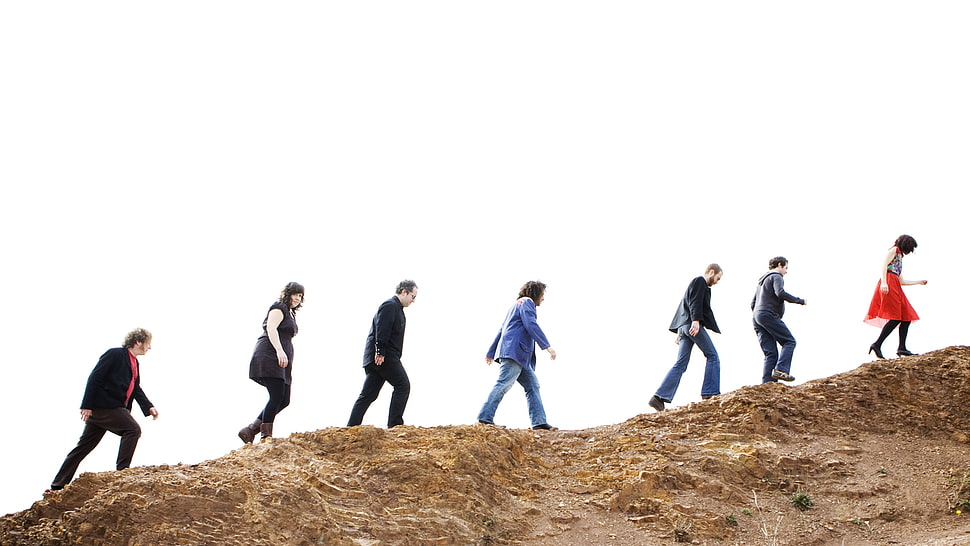 group of people walking on brown mountain during daytime photo HD wallpaper