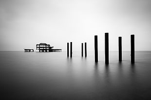 grayscale photo of structure on body of water