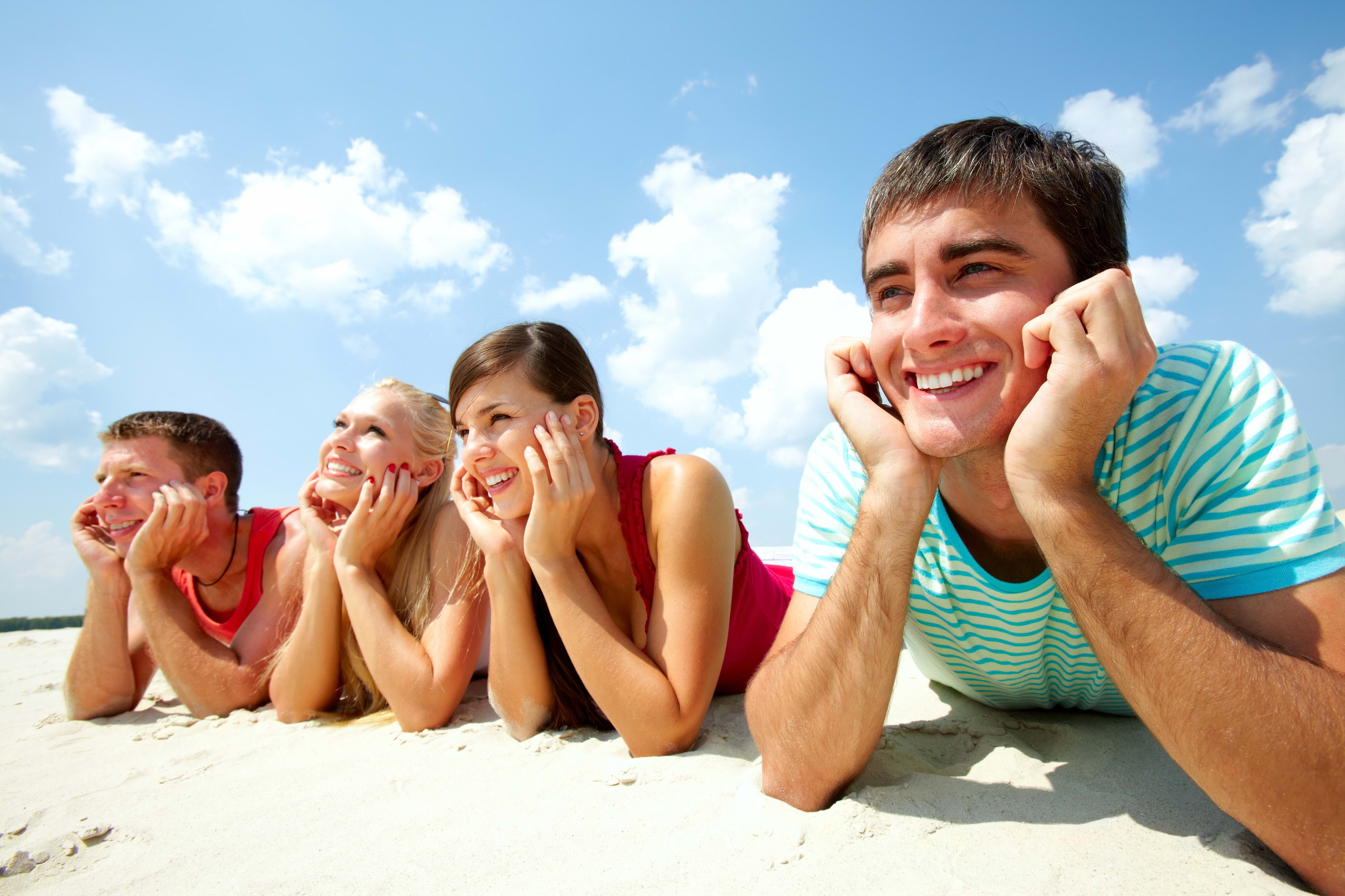 girl and two guys at the beach