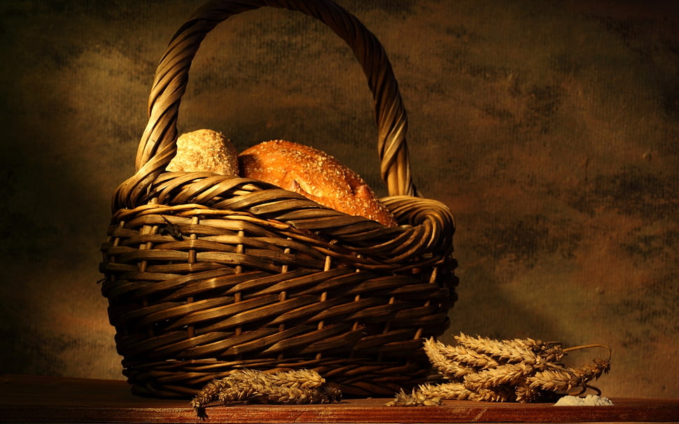 breads in brown wicker basket surrounded of wheats HD wallpaper