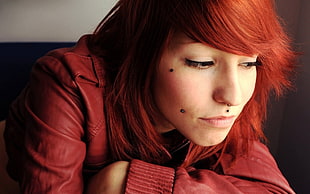 photo of woman wearing red leather jacket with red hair