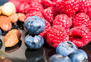 raspberry and blueberry on black surface HD wallpaper