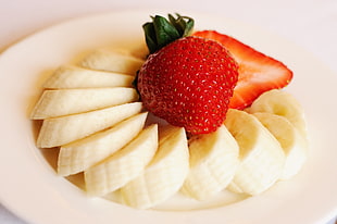 strawberry and banana slices on white ceramic plate