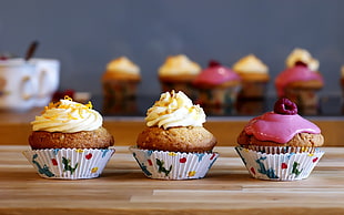 three baked cupcake with toppings