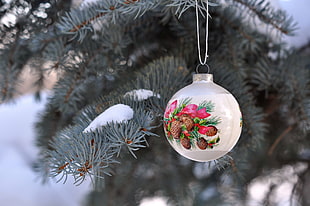 selective focus photography of white bauble hanging on tree
