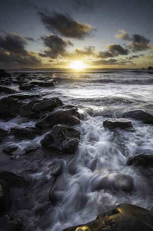 photography of rock and waves