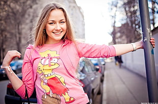 woman in pink, red, and yellow sweatshirt
