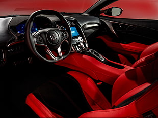 car with red bucket seats and black steering wheel
