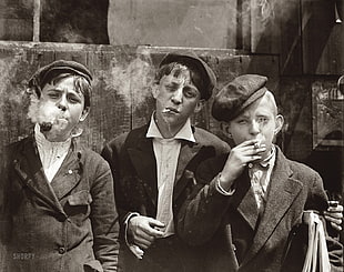 grayscale photo of three boy smoking