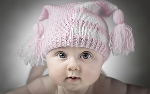 baby wearing white and pink knit cap