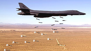 black fighter plane deploying missile bombs HD wallpaper