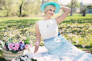 blonde haired woman wearing blue sunny hat and white sleeveless dress during daytime