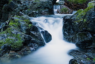 waterfalls beside rock formations during twilight HD wallpaper