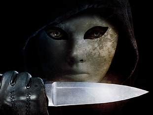 person in mask holding knife