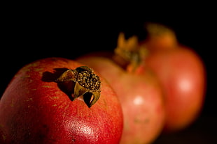 three close up photo of pomegranate fruits, pomegranates
