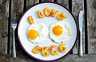 two white Sunny side up and I Love Eggs nuggets on white ceramic plate