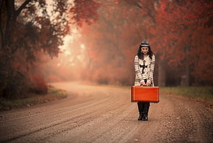 woman holding orange travel case HD wallpaper