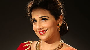 woman in red top wearing gold-jewelries
