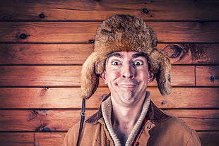man wearing brown leather turtle neck full-zip jacket and brown sheepskin hat HD wallpaper