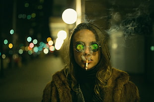 woman wearing brown fur jacket while smoking