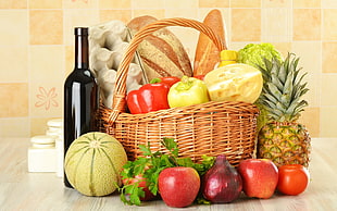 assorted fruits with basket and wine bottle