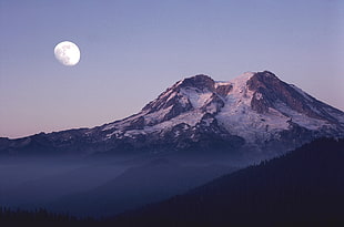 snow-covered mountain under blue sky and moon